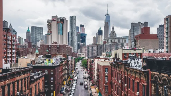View of brick buildings and One World Trade Center building and New York City skyline.